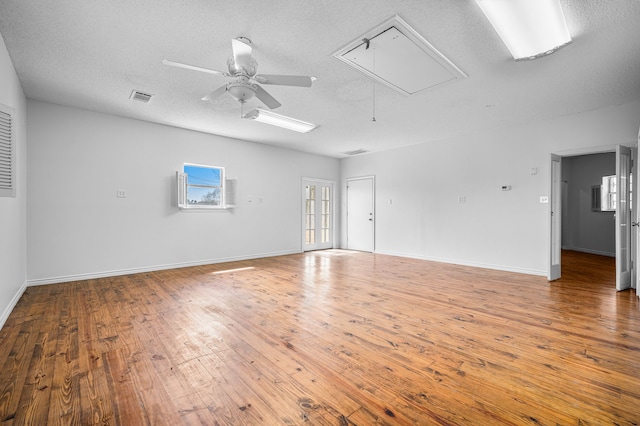 5327 Dusty Rd, Athens, TX 75752 - spare room with attic access, wood finished floors, a ceiling fan, a textured ceiling, and baseboards