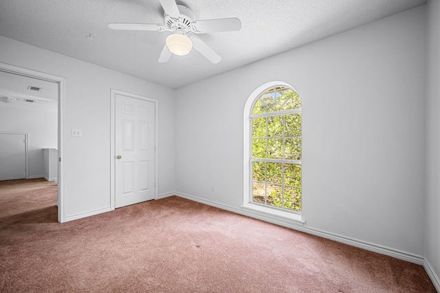 5327 Dusty Rd, Athens, TX 75752 - unfurnished bedroom with carpet floors, baseboards, a textured ceiling, and ceiling fan