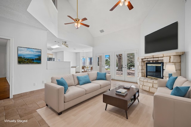5327 Dusty Rd, Athens, TX 75752 - living room with high vaulted ceiling, ceiling fan, baseboards, stone tile floors, and a stone fireplace