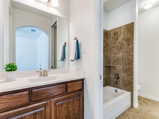 full bath featuring vanity,  shower combination, baseboards, toilet, and tile patterned flooring