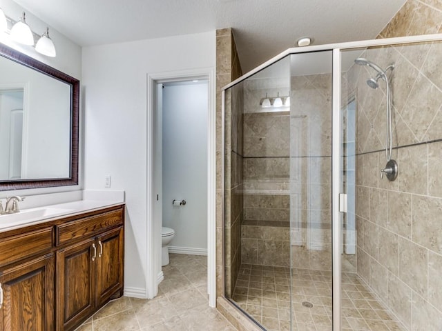 full bath featuring a shower stall, toilet, vanity, and tile patterned floors