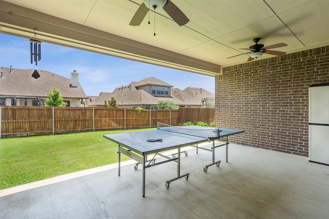 view of patio / terrace with a fenced backyard, a residential view, a ceiling fan, and outdoor dining space