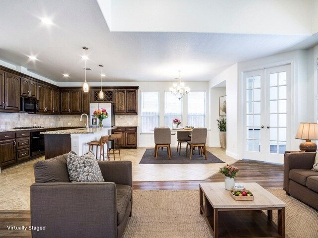 living room with recessed lighting and a notable chandelier