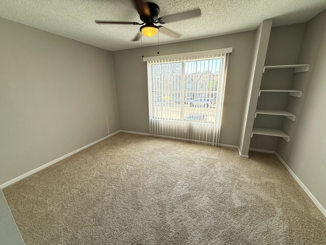 2240 Aspen Dr, Dallas, TX 75227 - carpeted spare room with baseboards, a textured ceiling, and a ceiling fan