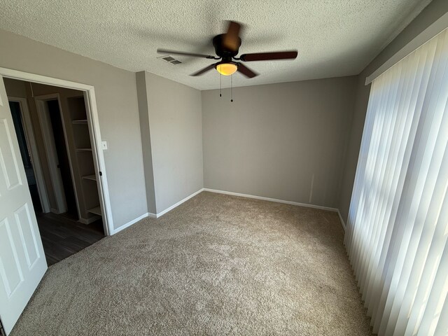 2240 Aspen Dr, Dallas, TX 75227 - unfurnished bedroom featuring visible vents, baseboards, carpet, and a textured ceiling