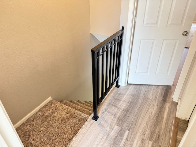 2240 Aspen Dr, Dallas, TX 75227 - stairs featuring wood finished floors and a textured wall