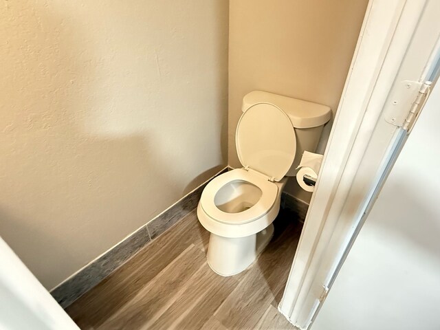 2240 Aspen Dr, Dallas, TX 75227 - bathroom with toilet, wood finished floors, and baseboards