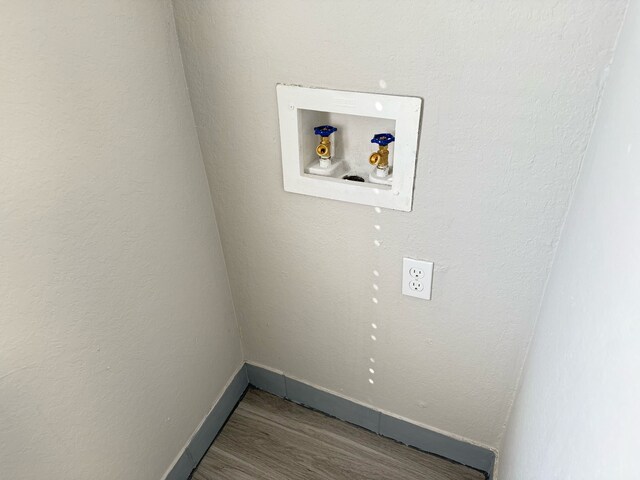 2240 Aspen Dr, Dallas, TX 75227 - clothes washing area featuring electric dryer hookup, wood finished floors, baseboards, hookup for a washing machine, and laundry area