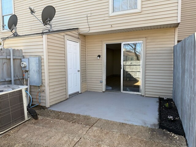 2240 Aspen Dr, Dallas, TX 75227 - property entrance with central AC unit, a patio, and fence