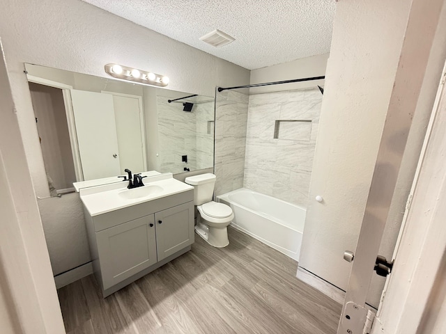 2240 Aspen Dr, Dallas, TX 75227 - bathroom featuring visible vents, toilet, wood finished floors, a textured wall, and a textured ceiling