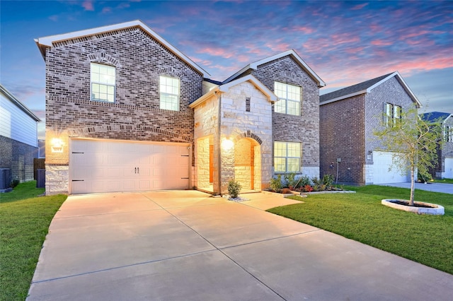 view of front of house with central air condition unit, a lawn, driveway, stone siding, and an attached garage