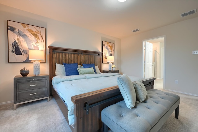 bedroom featuring visible vents, light colored carpet, and baseboards