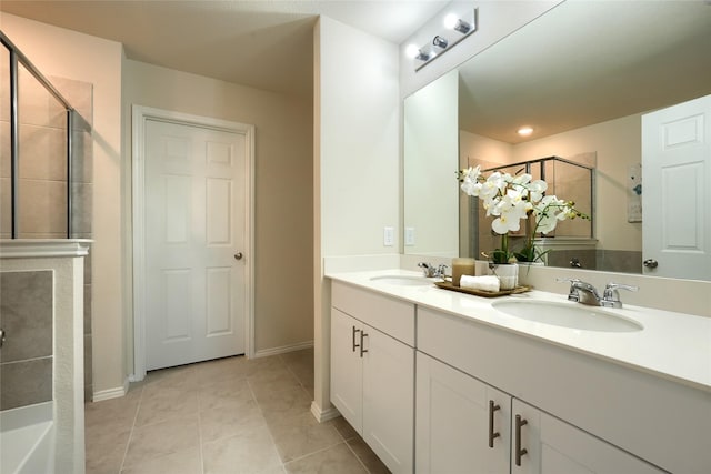 full bath with tile patterned flooring, a stall shower, double vanity, and a sink