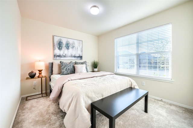 bedroom featuring carpet flooring and baseboards