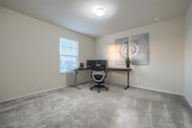 carpeted office featuring baseboards