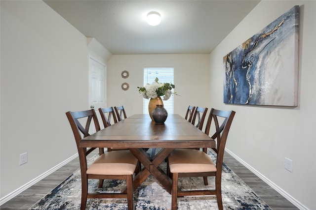 dining room with baseboards and dark wood-style flooring