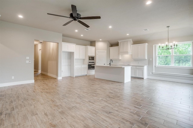 312 Falcon Ct, Springtown, TX 76082 - unfurnished living room with a ceiling fan, baseboards, a chandelier, light wood-style floors, and a sink