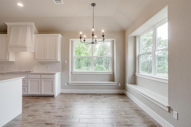 312 Falcon Ct, Springtown, TX 76082 - kitchen with plenty of natural light, a chandelier, backsplash, and light countertops