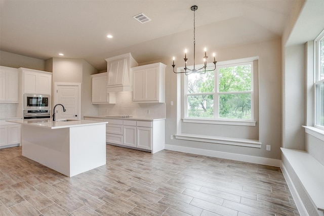 312 Falcon Ct, Springtown, TX 76082 - kitchen with appliances with stainless steel finishes, a sink, a chandelier, decorative backsplash, and recessed lighting