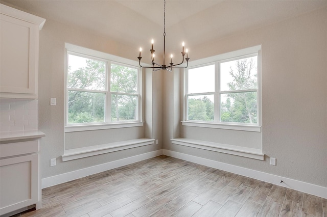 312 Falcon Ct, Springtown, TX 76082 - unfurnished dining area with a chandelier, baseboards, and light wood-type flooring