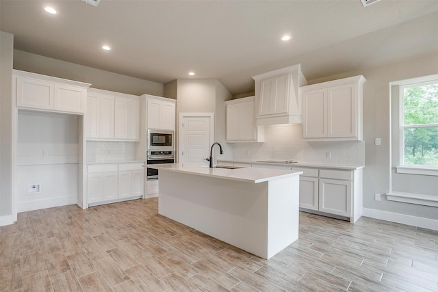 312 Falcon Ct, Springtown, TX 76082 - kitchen with a sink, stainless steel oven, decorative backsplash, white cabinetry, and recessed lighting