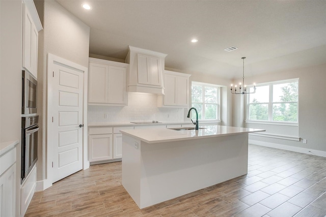 312 Falcon Ct, Springtown, TX 76082 - kitchen featuring appliances with stainless steel finishes, a sink, light countertops, tasteful backsplash, and a chandelier