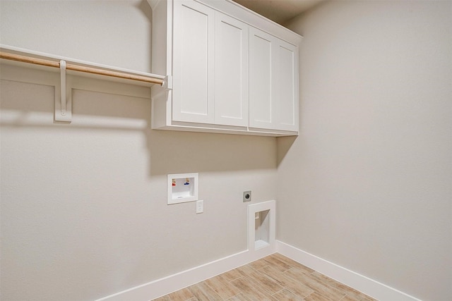312 Falcon Ct, Springtown, TX 76082 - laundry area featuring baseboards, hookup for an electric dryer, cabinet space, light wood finished floors, and washer hookup