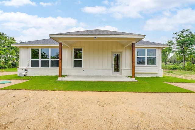 312 Falcon Ct, Springtown, TX 76082 - rear view of property featuring a patio area, a lawn, and a shingled roof