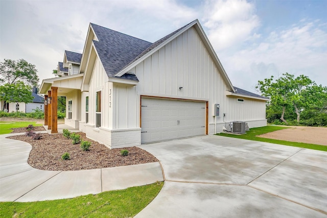 312 Falcon Ct, Springtown, TX 76082 - view of home's exterior with a shingled roof, board and batten siding, a garage, concrete driveway, and central air condition unit