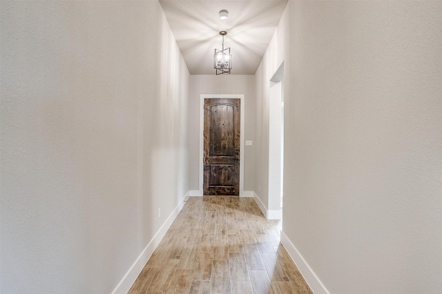 312 Falcon Ct, Springtown, TX 76082 - doorway with a chandelier, light wood-type flooring, and baseboards