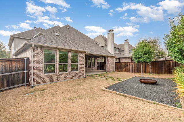 2112 Nassau Dr, Mckinney, TX 75071 - rear view of property with a patio, brick siding, roof with shingles, and fence