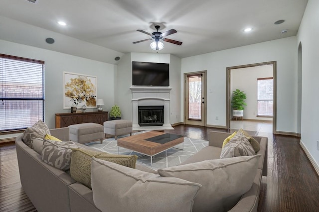 4406 Winding Glen Ln, Mansfield, TX 76063 - living area with a fireplace with raised hearth, a ceiling fan, wood finished floors, baseboards, and recessed lighting