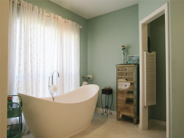 1430 State Highway 87 S, Hemphill, TX 75948 - full bathroom featuring a soaking tub and baseboards