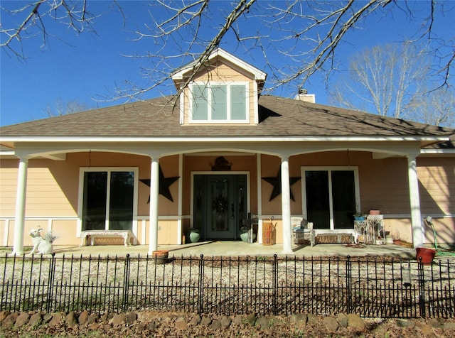 1430 State Highway 87 S, Hemphill, TX 75948 - back of house featuring a fenced front yard, a porch, a chimney, and a shingled roof
