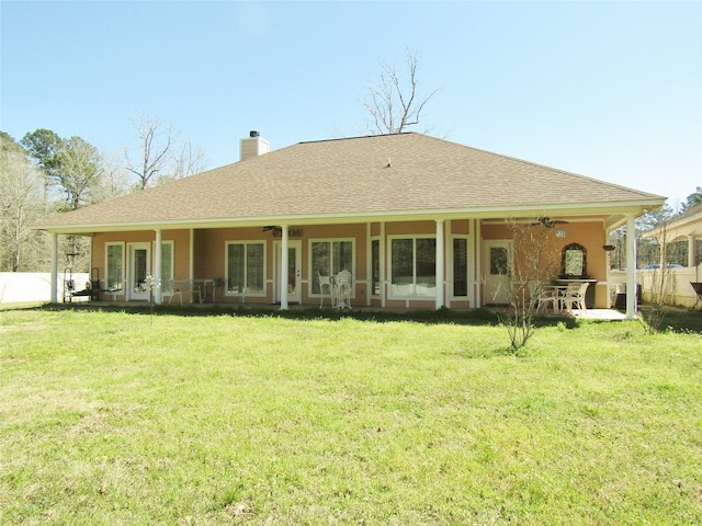 1430 State Highway 87 S, Hemphill, TX 75948 - rear view of property featuring a ceiling fan, a shingled roof, a chimney, and a lawn