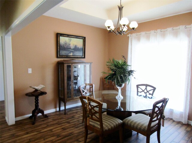 1430 State Highway 87 S, Hemphill, TX 75948 - dining area featuring a notable chandelier, a raised ceiling, dark wood-type flooring, and baseboards