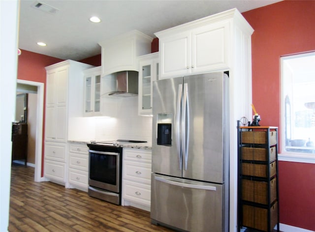 1430 State Highway 87 S, Hemphill, TX 75948 - kitchen with visible vents, appliances with stainless steel finishes, wall chimney exhaust hood, and white cabinets