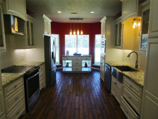 1430 State Highway 87 S, Hemphill, TX 75948 - kitchen featuring visible vents, a sink, appliances with stainless steel finishes, glass insert cabinets, and light stone countertops