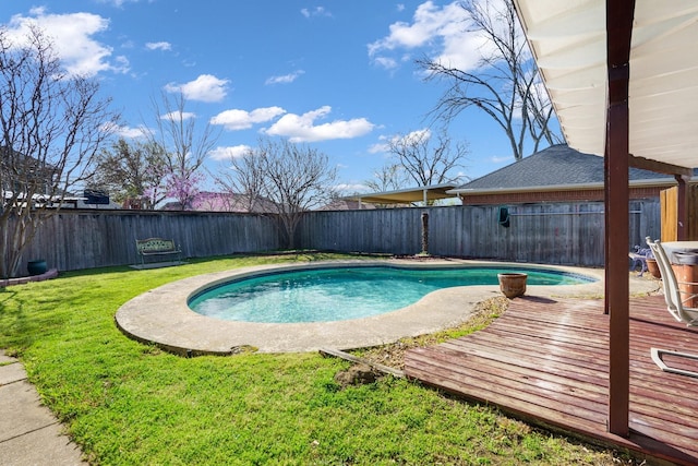 view of pool with a lawn, a fenced in pool, a wooden deck, and a fenced backyard