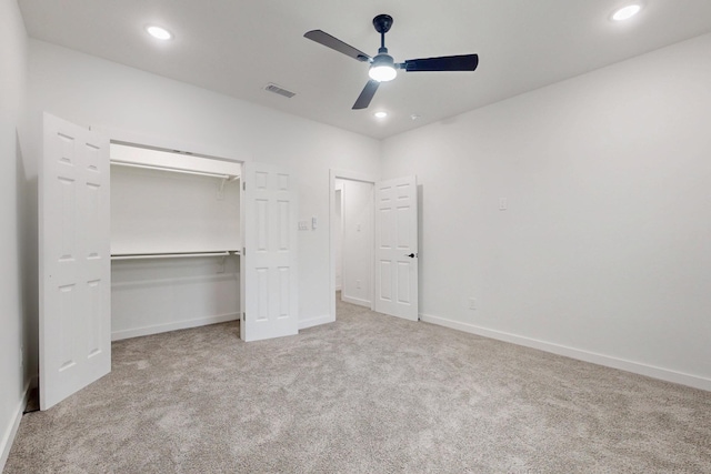unfurnished bedroom with a closet, carpet, baseboards, visible vents, and recessed lighting