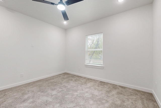 carpeted empty room with baseboards, a ceiling fan, and recessed lighting