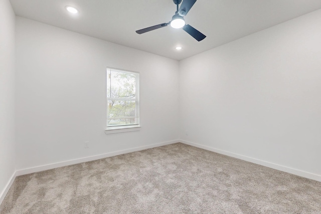 carpeted spare room featuring baseboards, a ceiling fan, and recessed lighting