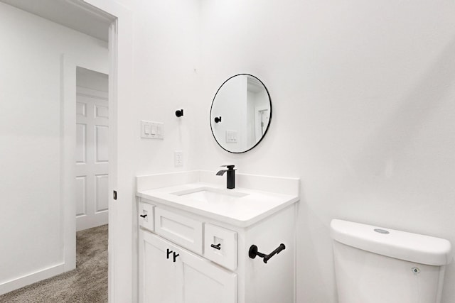 half bathroom with toilet and vanity