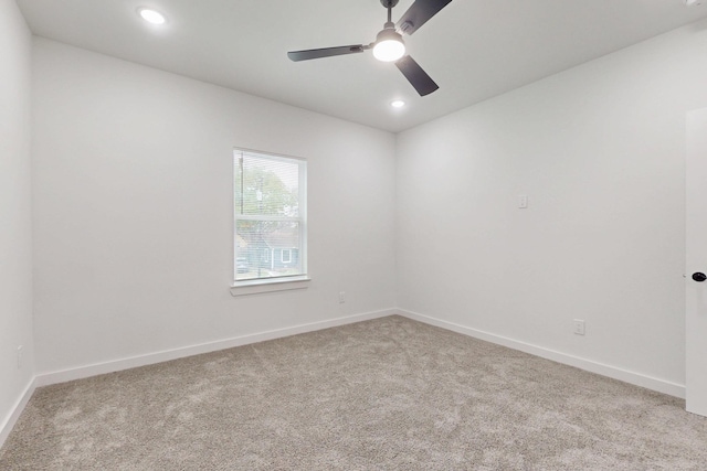 empty room featuring baseboards, carpet floors, and ceiling fan