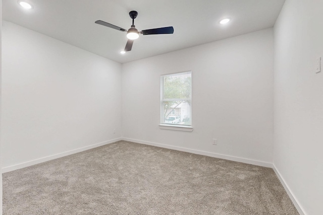 empty room with recessed lighting, carpet floors, a ceiling fan, and baseboards