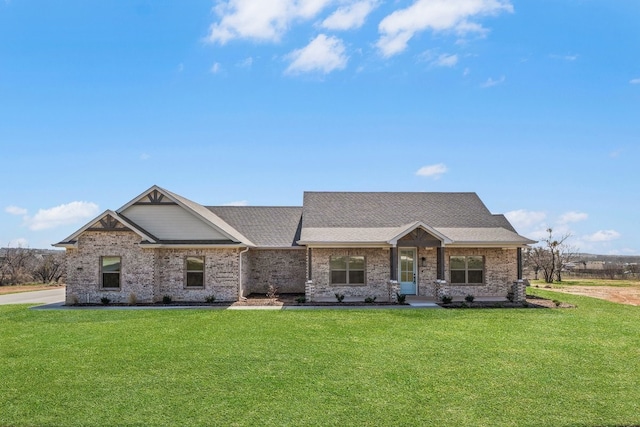 405 Red Roan Rdg, Brock, TX 76087 - view of front facade with a front yard, brick siding, and a shingled roof
