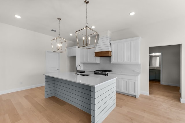 405 Red Roan Rdg, Brock, TX 76087 - kitchen featuring a sink, white cabinetry, custom exhaust hood, and gas stove