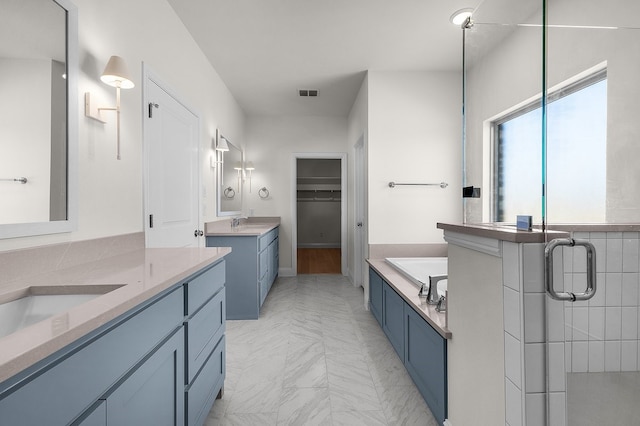 405 Red Roan Rdg, Brock, TX 76087 - bathroom featuring visible vents, a garden tub, two vanities, a stall shower, and a sink