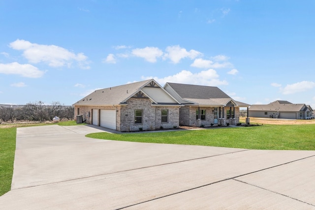 405 Red Roan Rdg, Brock, TX 76087 - view of front of home with a front lawn, concrete driveway, an attached garage, brick siding, and central AC unit