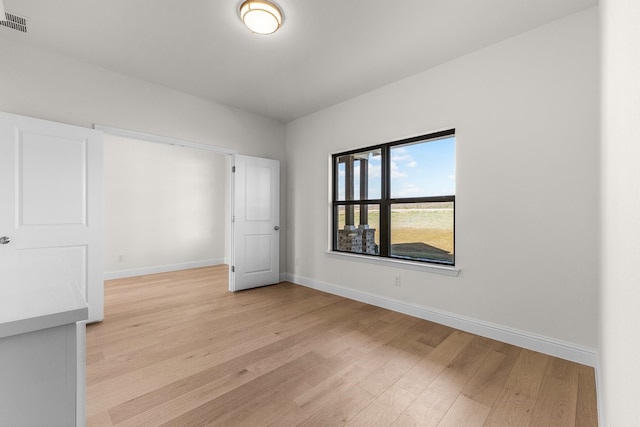 405 Red Roan Rdg, Brock, TX 76087 - spare room featuring visible vents, baseboards, and light wood-style floors